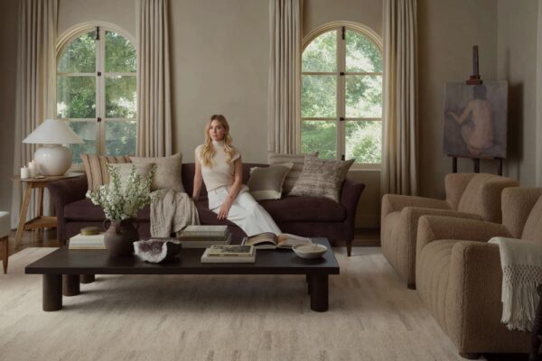 Amber Lewis in elegant living room with plush Rug and decor.