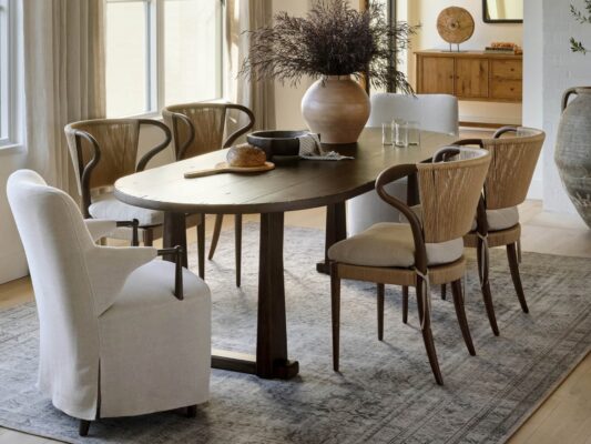 Elegant dining room with rustic wooden table and chairs.