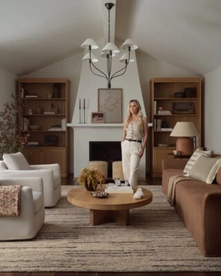 Amber Lewis standing in stylish, well-decorated living room.