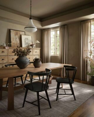 Cozy rustic dining room with natural light and wooden furniture.